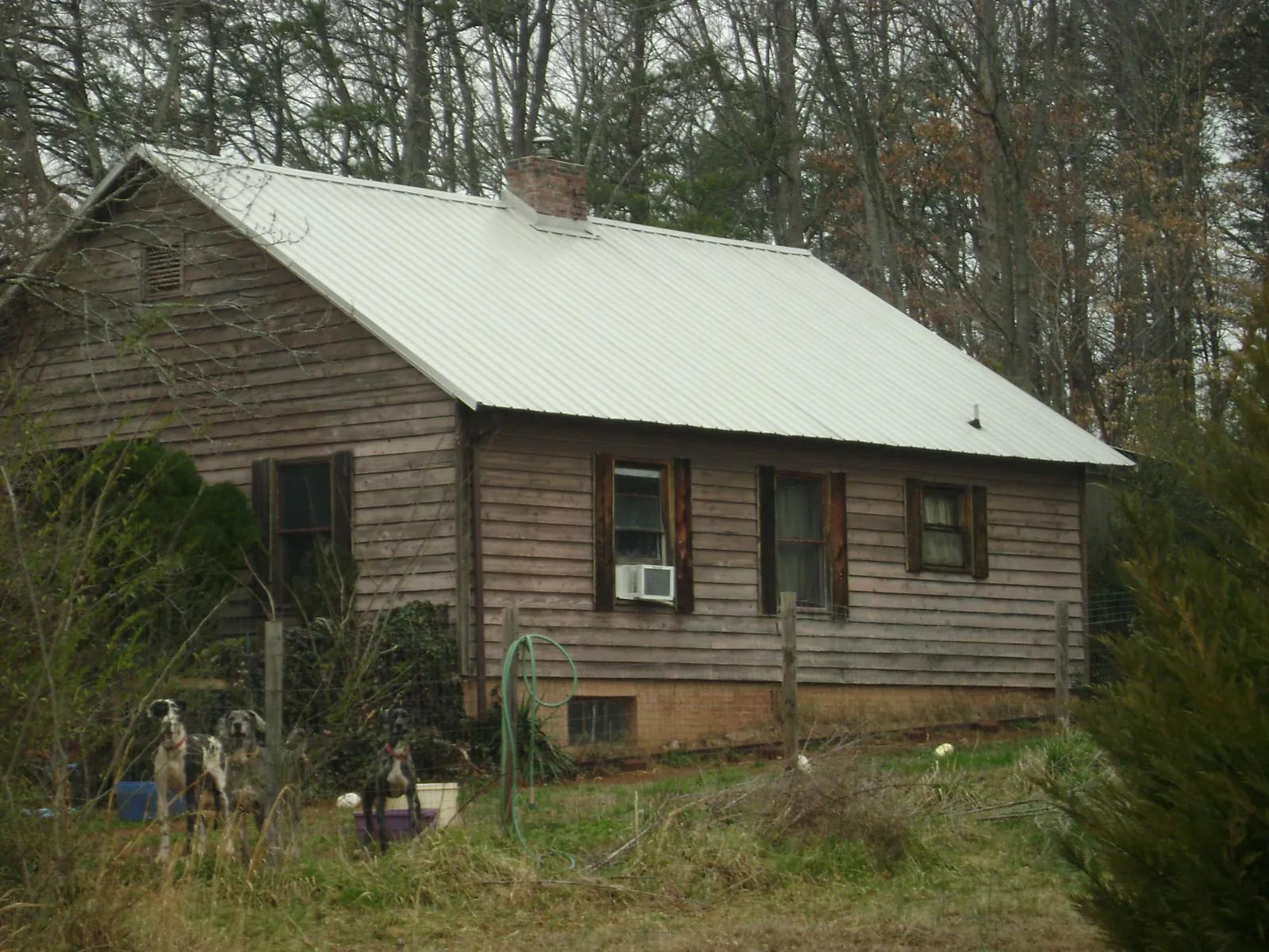 White metal roof on an old wood sided farmhouse, from a Metal Roof Installation job in Candia